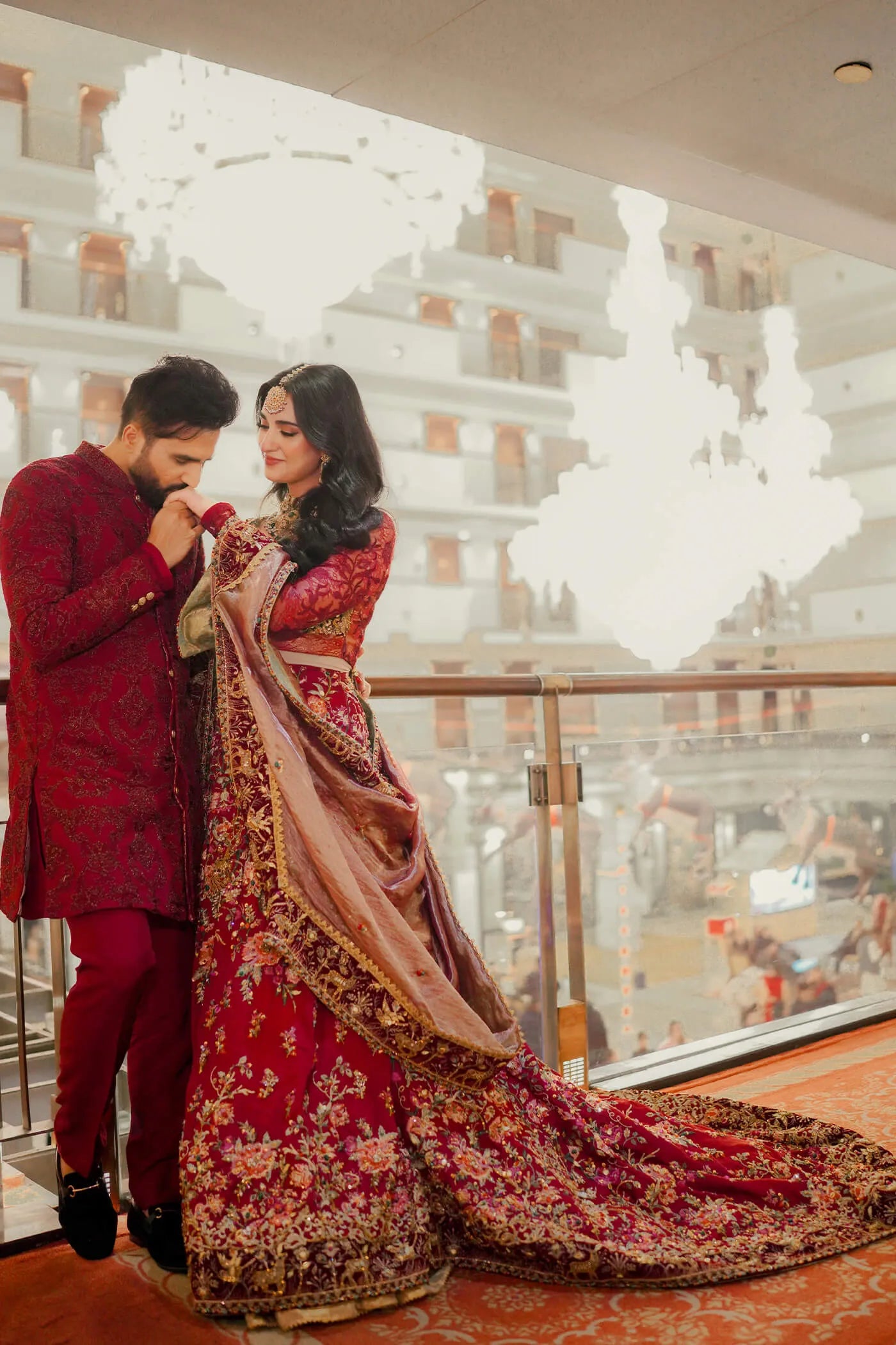 Couple in Musferah Saad Scarlet Monarch, Pakistani bridal dress and sherwani in UK.