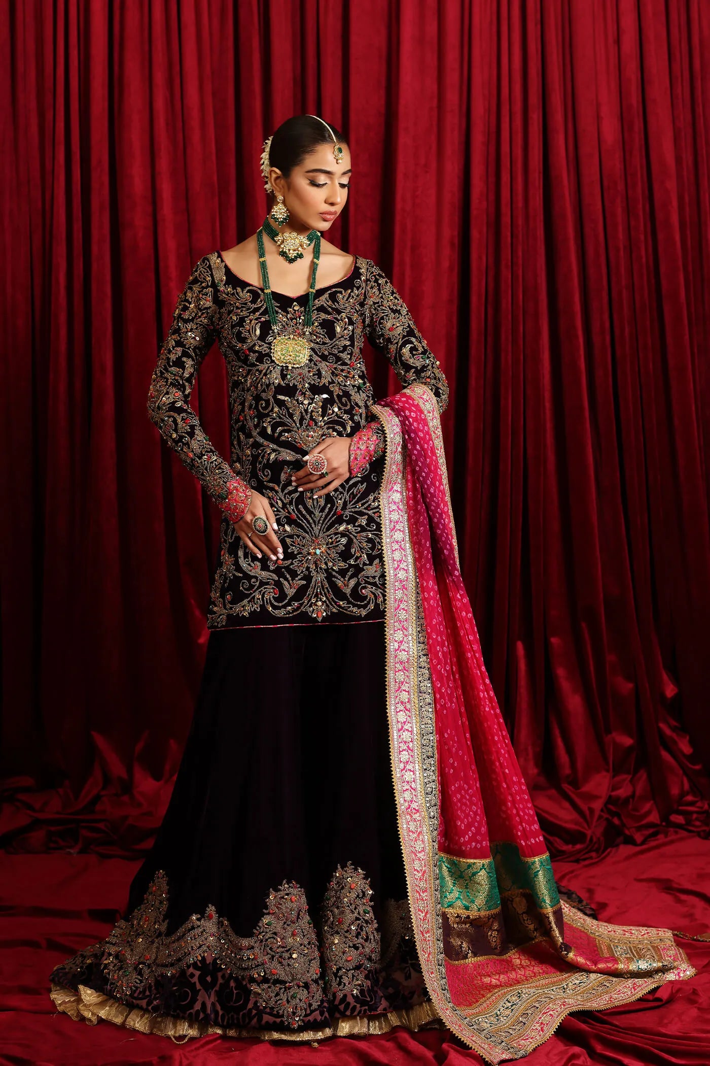 Model in Musferah Saad Velvet Symphony, opulent Pakistani bridal attire in UK.