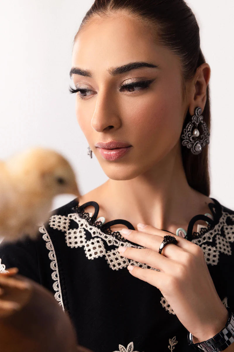 Model wearing black embroidered dress from Qalamkar Basic Pret '25 KT-07 Mahira, Saffron Pakistani Luxury pret available online in UK.