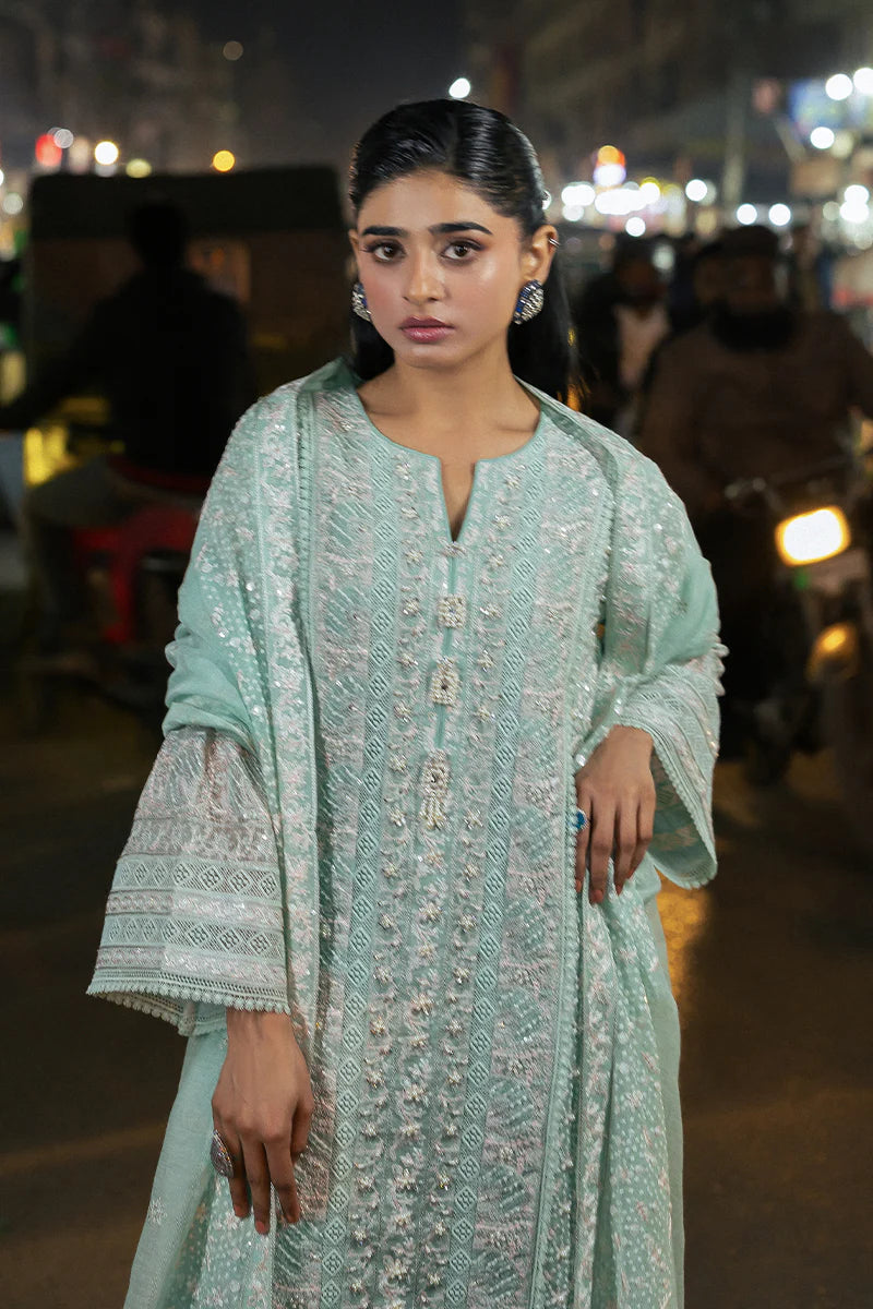 Model wearing Mushq Saugaat City of Lights Shama in mint green with intricate embroidery and embellishments. Shop Pakistani luxury pret online in the UK.
