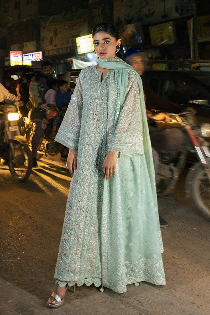 Model wearing Mushq Saugaat City of Lights Shama in mint green with intricate embroidery and embellishments. Shop Pakistani luxury pret online in the UK.
