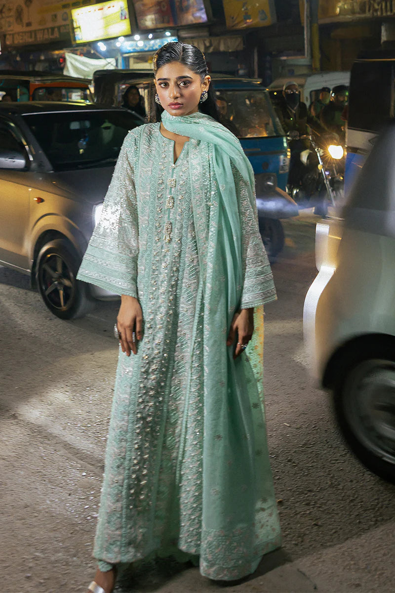 Model wearing Mushq Saugaat City of Lights Shama in mint green with intricate embroidery and embellishments. Shop Pakistani luxury pret online in the UK.
