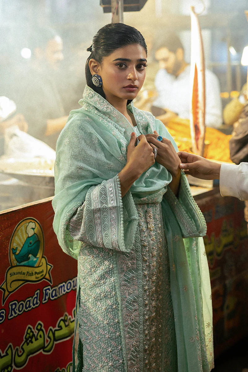 Model wearing Mushq Saugaat City of Lights Shama in mint green with intricate embroidery and embellishments. Shop Pakistani luxury pret online in the UK.