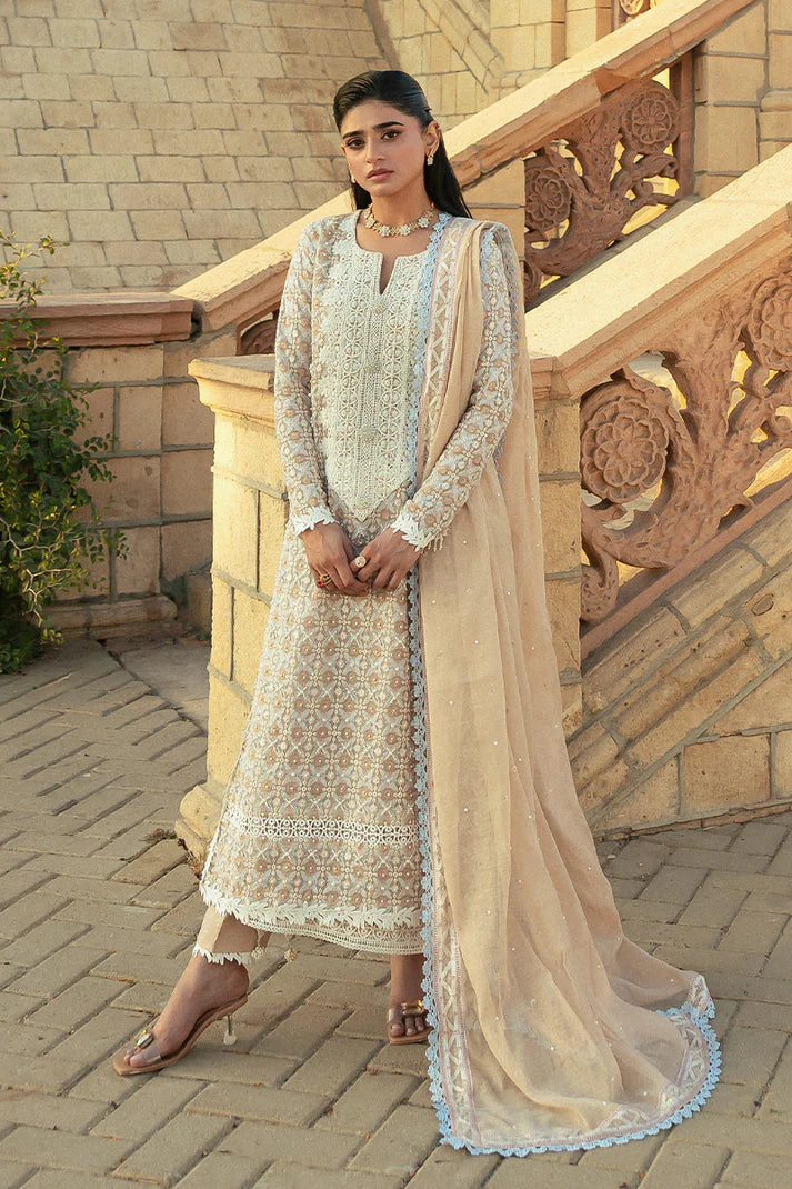 Model wearing Mushq Saugaat City of Lights Faria in beige with intricate embroidery. Shop Pakistani luxury pret online in the UK.