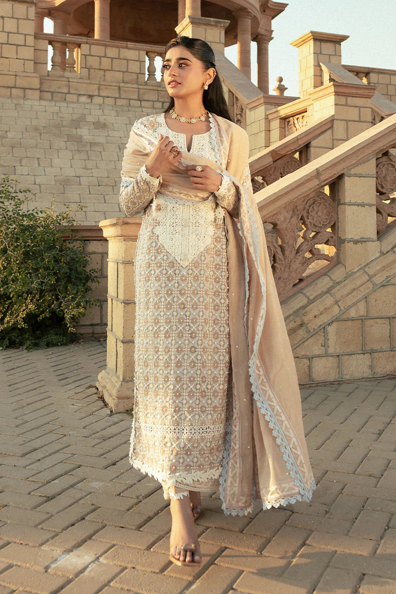 Model wearing Mushq Saugaat City of Lights Faria in beige with intricate embroidery. Shop Pakistani luxury pret online in the UK.