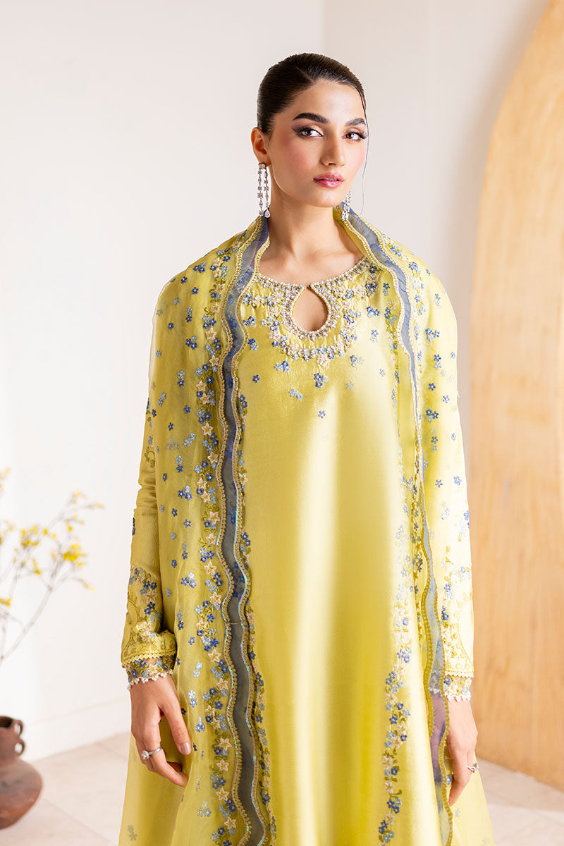Model wearing lemon yellow Lumiere dress from Mushq with delicate blue embroidery, perfect for Pakistani luxury pret and clothes online in UK.