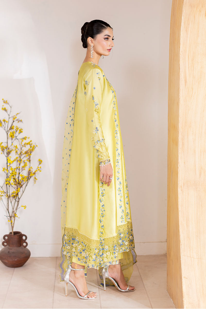 Model wearing lemon yellow Lumiere dress from Mushq with delicate blue embroidery, perfect for Pakistani luxury pret and clothes online in UK.