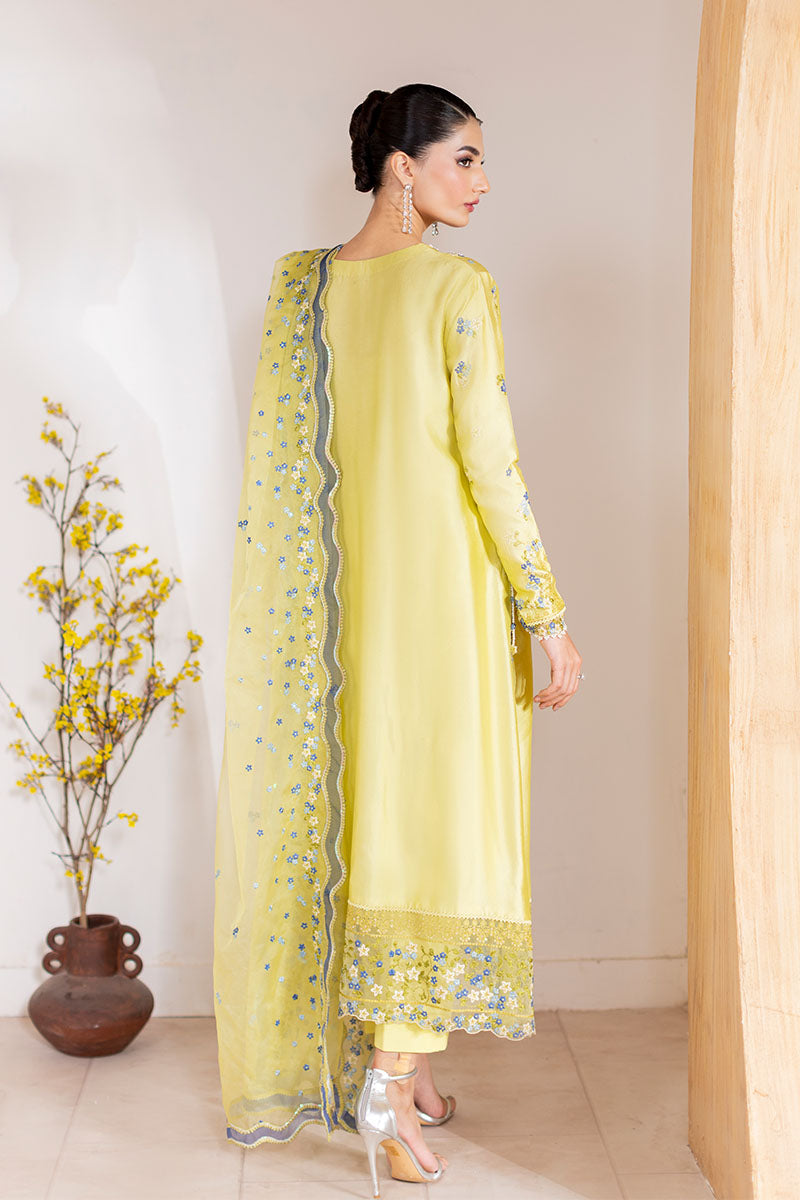 Model wearing lemon yellow Lumiere dress from Mushq with delicate blue embroidery, perfect for Pakistani luxury pret and clothes online in UK.