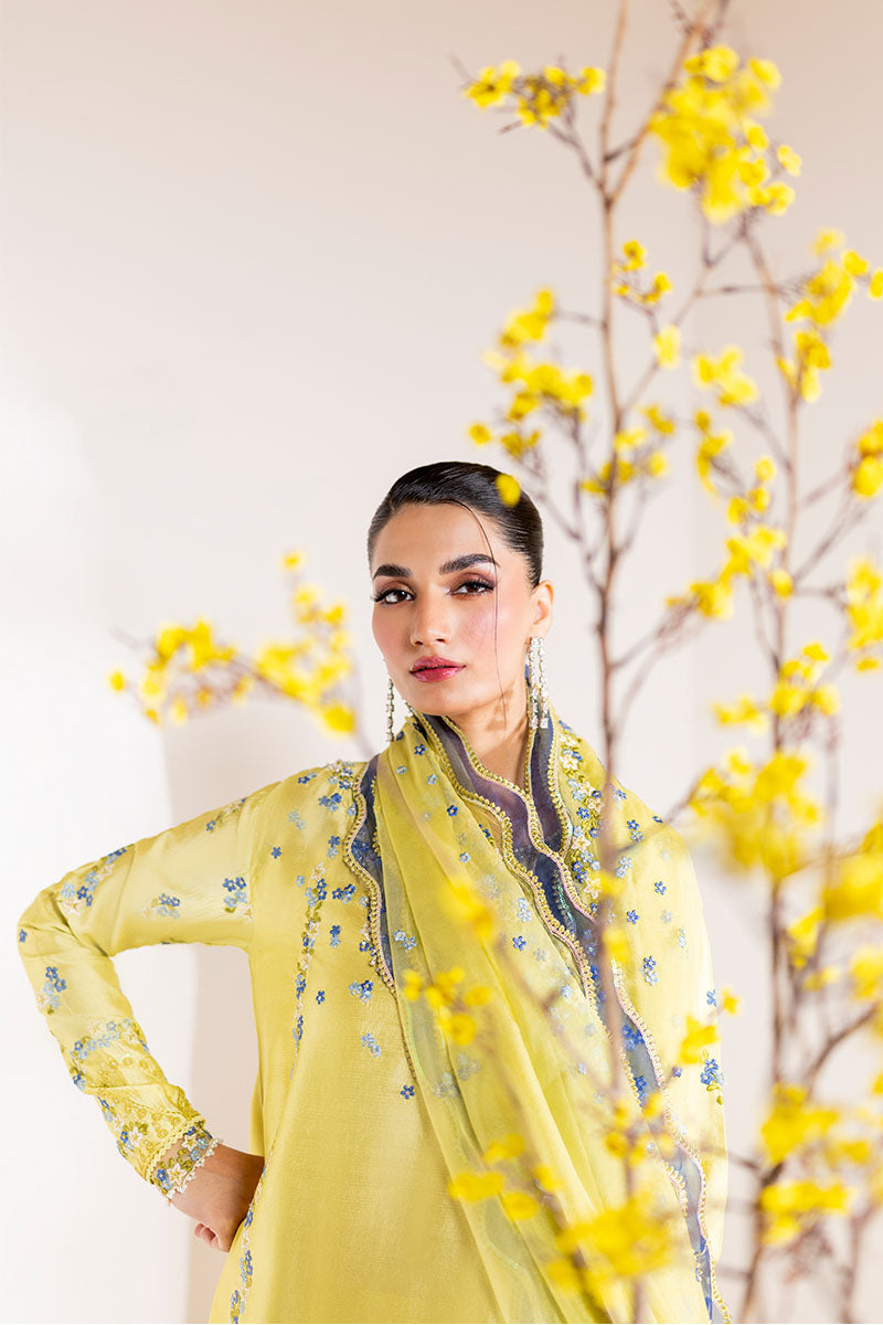 Model wearing lemon yellow Lumiere dress from Mushq with delicate blue embroidery, perfect for Pakistani luxury pret and clothes online in UK.
