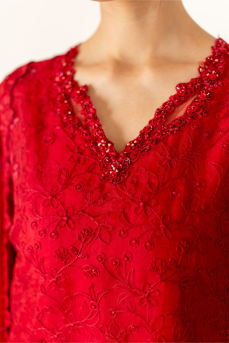 Model wearing deep red Rubea dress from Mushq, featuring intricate embroidery for Pakistani luxury pret and Pakistani clothes online in UK.
