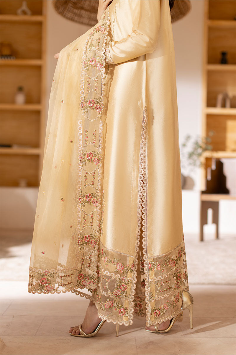 Model wearing golden Aurea dress from Mushq featuring intricate embellishments, ideal for Pakistani luxury pret and clothes online in UK.