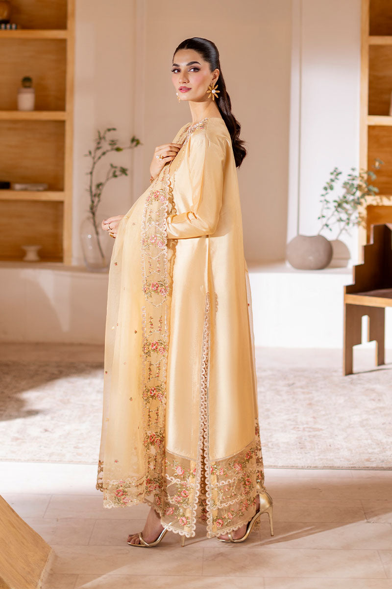Model wearing golden Aurea dress from Mushq featuring intricate embellishments, ideal for Pakistani luxury pret and clothes online in UK.