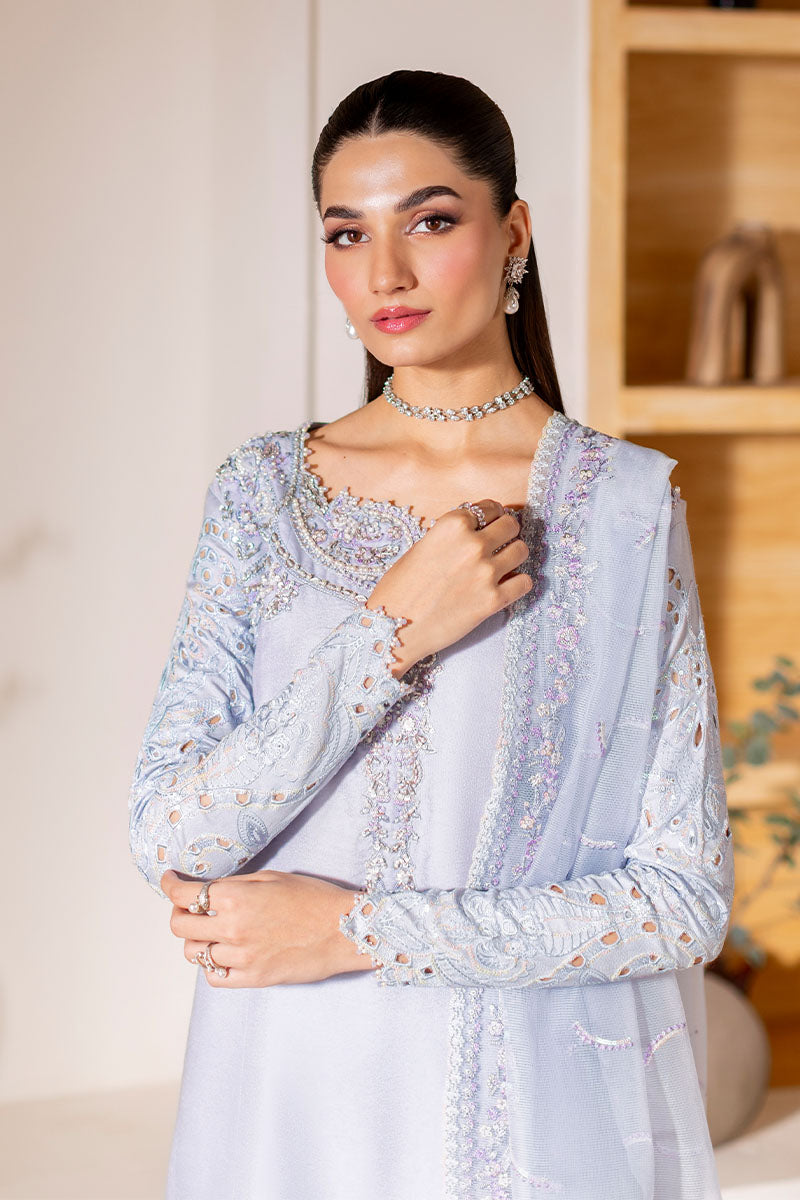 Model wearing ice blue Verve dress from Mushq, showcasing elegant embroidery for Pakistani luxury pret and Pakistani clothes online in UK.