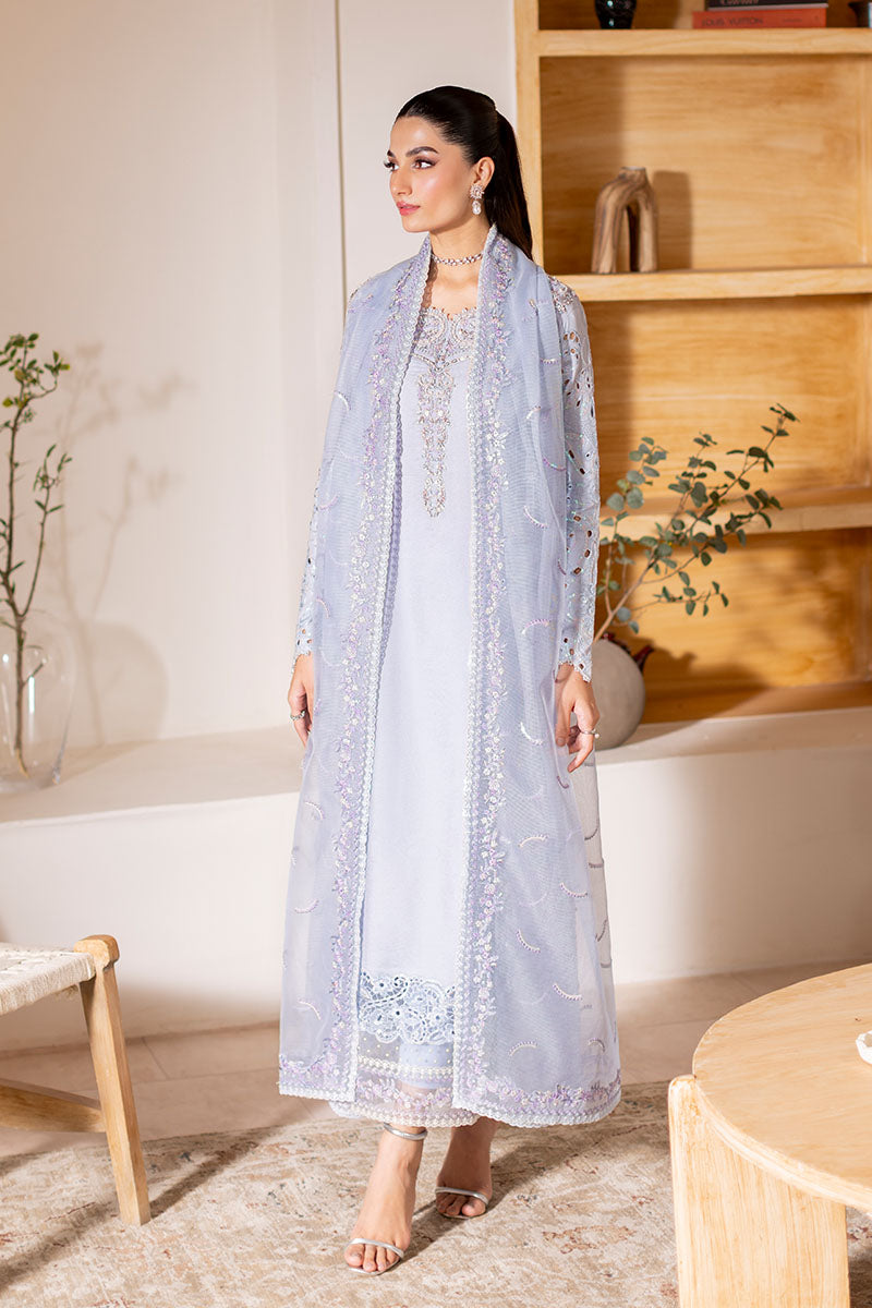 Model wearing ice blue Verve dress from Mushq, showcasing elegant embroidery for Pakistani luxury pret and Pakistani clothes online in UK.