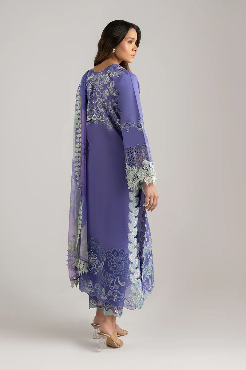 Model wearing purple embroidered dress with mint accents from Mushq Manaram Luxury Lawn '25 Luminous Essence, Pakistani clothes online in UK.