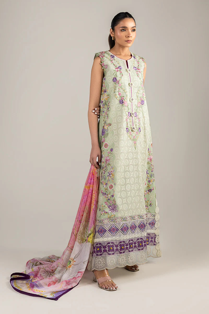 Model wearing sleeveless pastel green embroidered dress with floral pink dupatta from Mushq Manaram Luxury Lawn '25 Beaming Drift, Pakistani clothes online in UK.