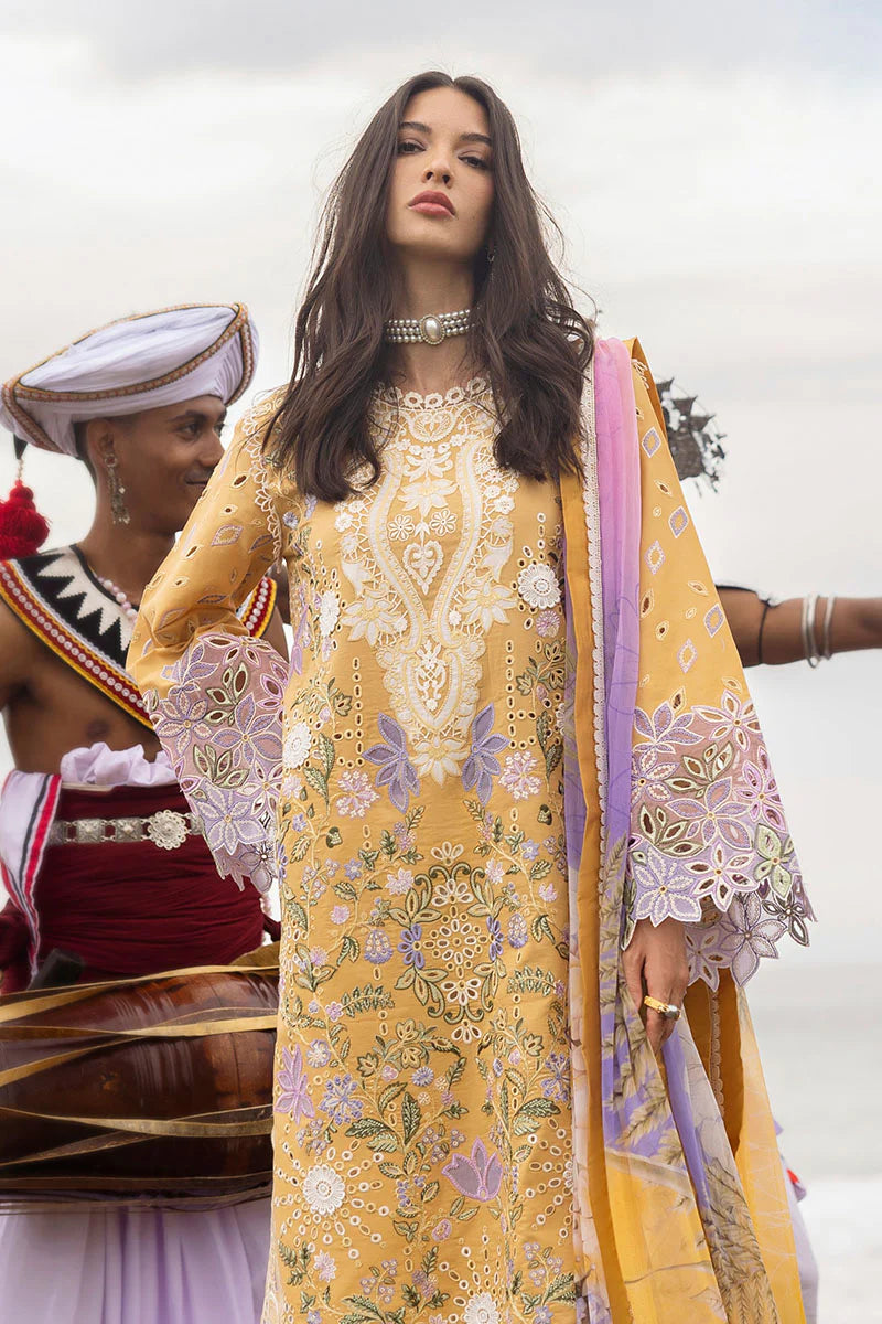 Model wearing mustard yellow embroidered floral shirt with lavender accents from Mushq Manaram Luxury Lawn 2025 Gold Glow. Pakistani clothes online UK.