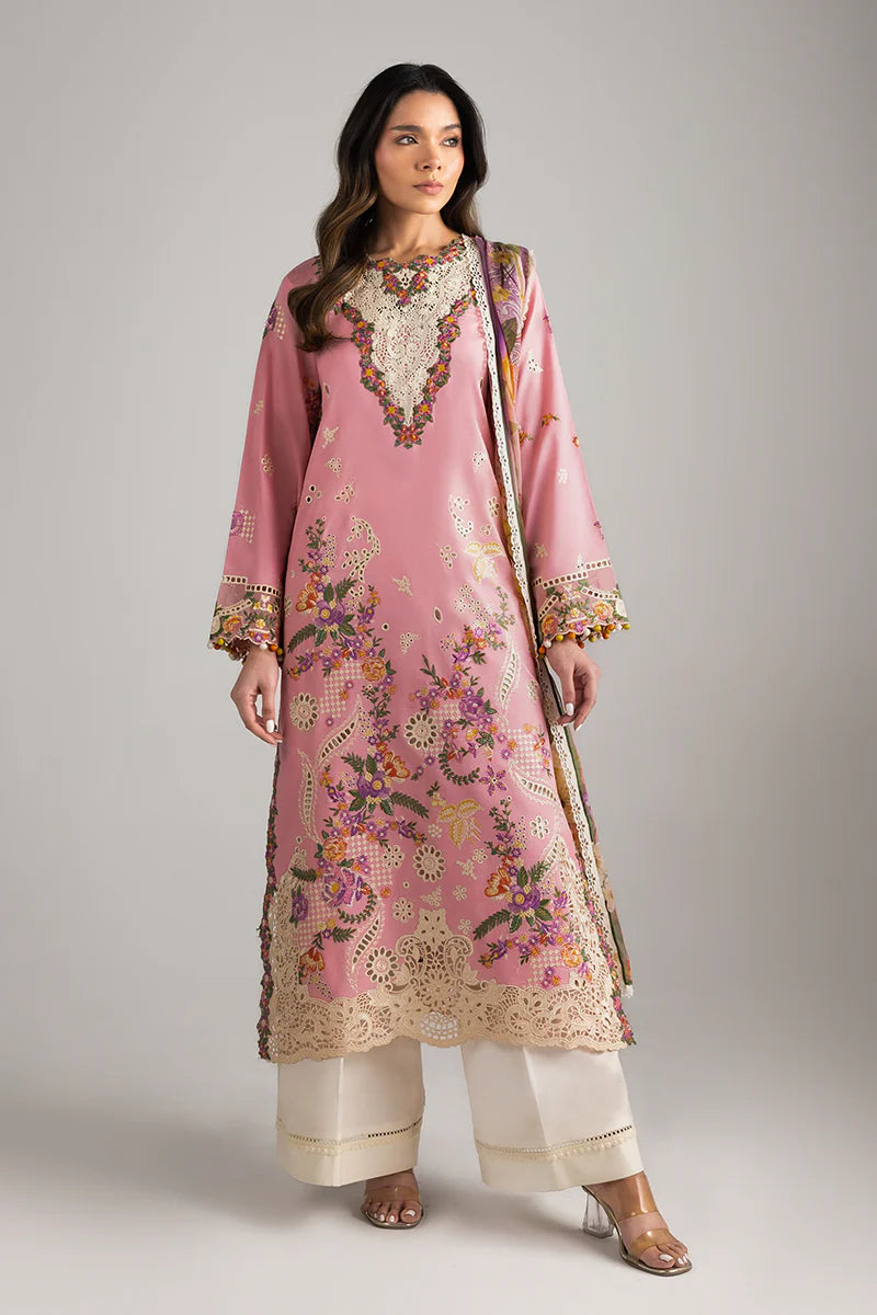 Model wearing blush pink embroidered dress with floral detailing and lace border from Mushq Manaram Luxury Lawn '25 Twinkling Tempos, Pakistani clothes online in UK.