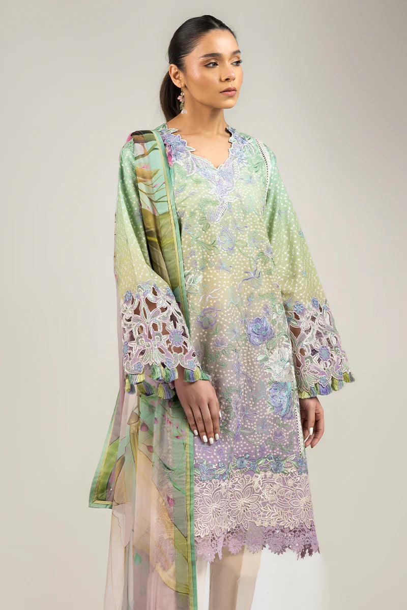 Model wearing pastel green and lavender embroidered dress from Mushq Manaram Luxury Lawn 2025 Glittering Grace. Pakistani clothes online UK.