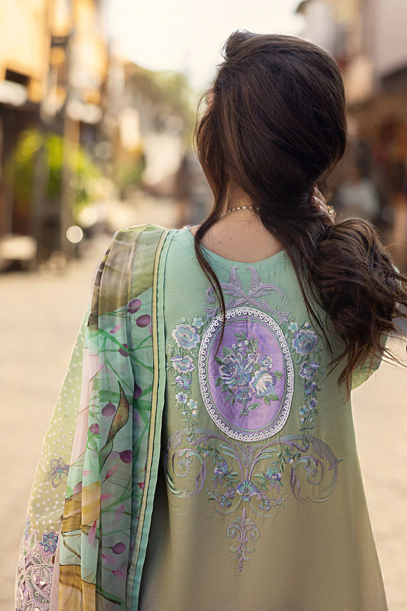 Model wearing pastel green and lavender embroidered dress from Mushq Manaram Luxury Lawn 2025 Glittering Grace. Pakistani clothes online UK.