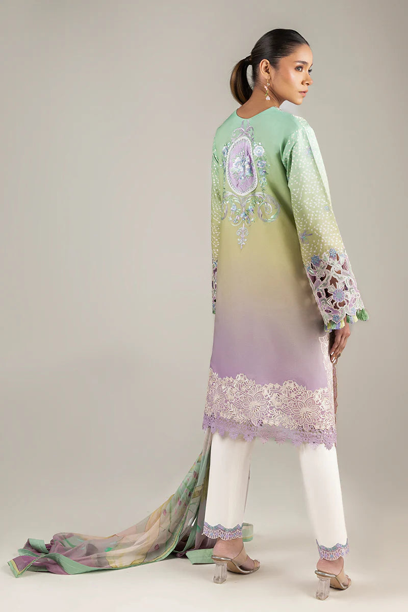 Model wearing pastel green and lavender embroidered dress from Mushq Manaram Luxury Lawn 2025 Glittering Grace. Pakistani clothes online UK.