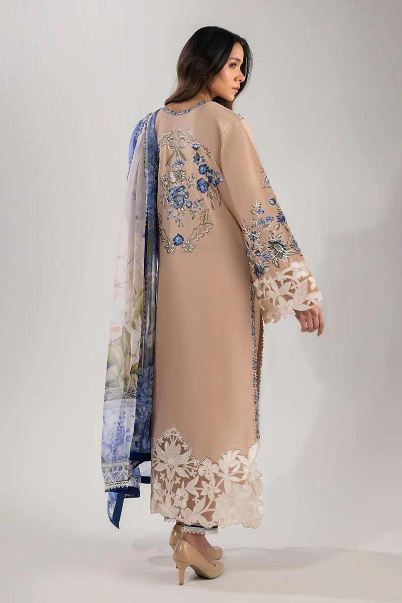 Model wearing beige and blue floral embroidered dress from Mushq Manaram Luxury Lawn '25 Glistening Groove, Pakistani clothes online in UK.