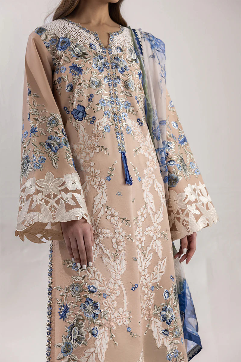 Model wearing beige and blue floral embroidered dress from Mushq Manaram Luxury Lawn '25 Glistening Groove, Pakistani clothes online in UK.