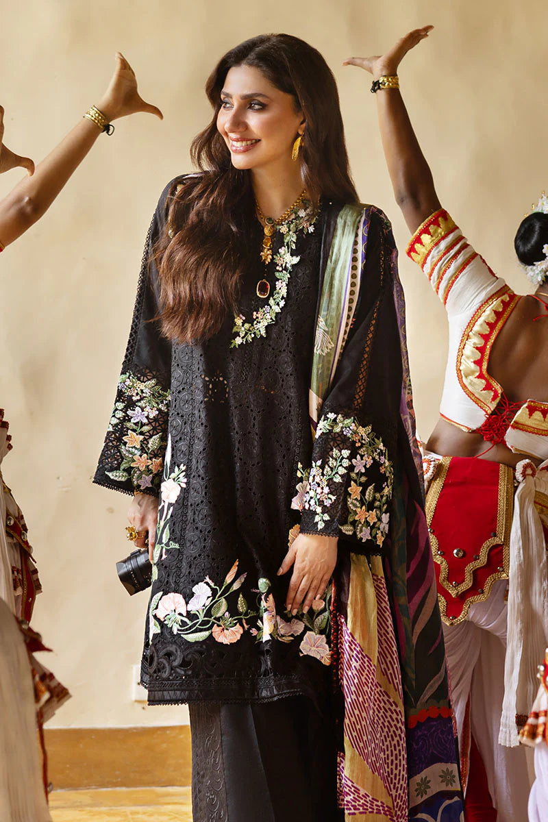 Model wearing black embroidered floral shirt with matching trousers and multicolour dupatta from Mushq Manaram Luxury Lawn 2025 Dazzling Glimmer. Pakistani clothes online UK.