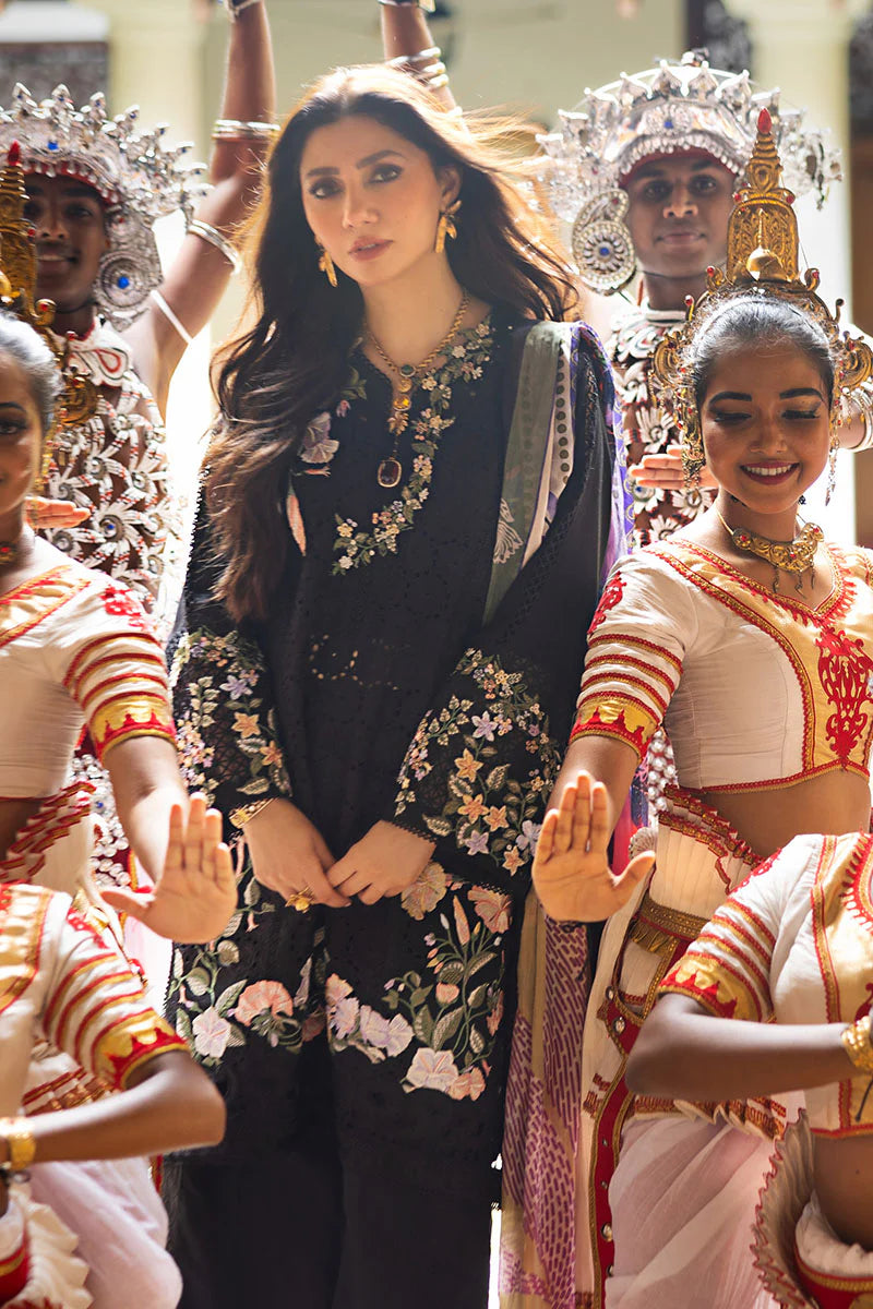 Model wearing black embroidered floral shirt with matching trousers and multicolour dupatta from Mushq Manaram Luxury Lawn 2025 Dazzling Glimmer. Pakistani clothes online UK.