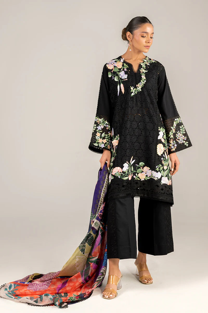 Model wearing black embroidered floral shirt with matching trousers and multicolour dupatta from Mushq Manaram Luxury Lawn 2025 Dazzling Glimmer. Pakistani clothes online UK.