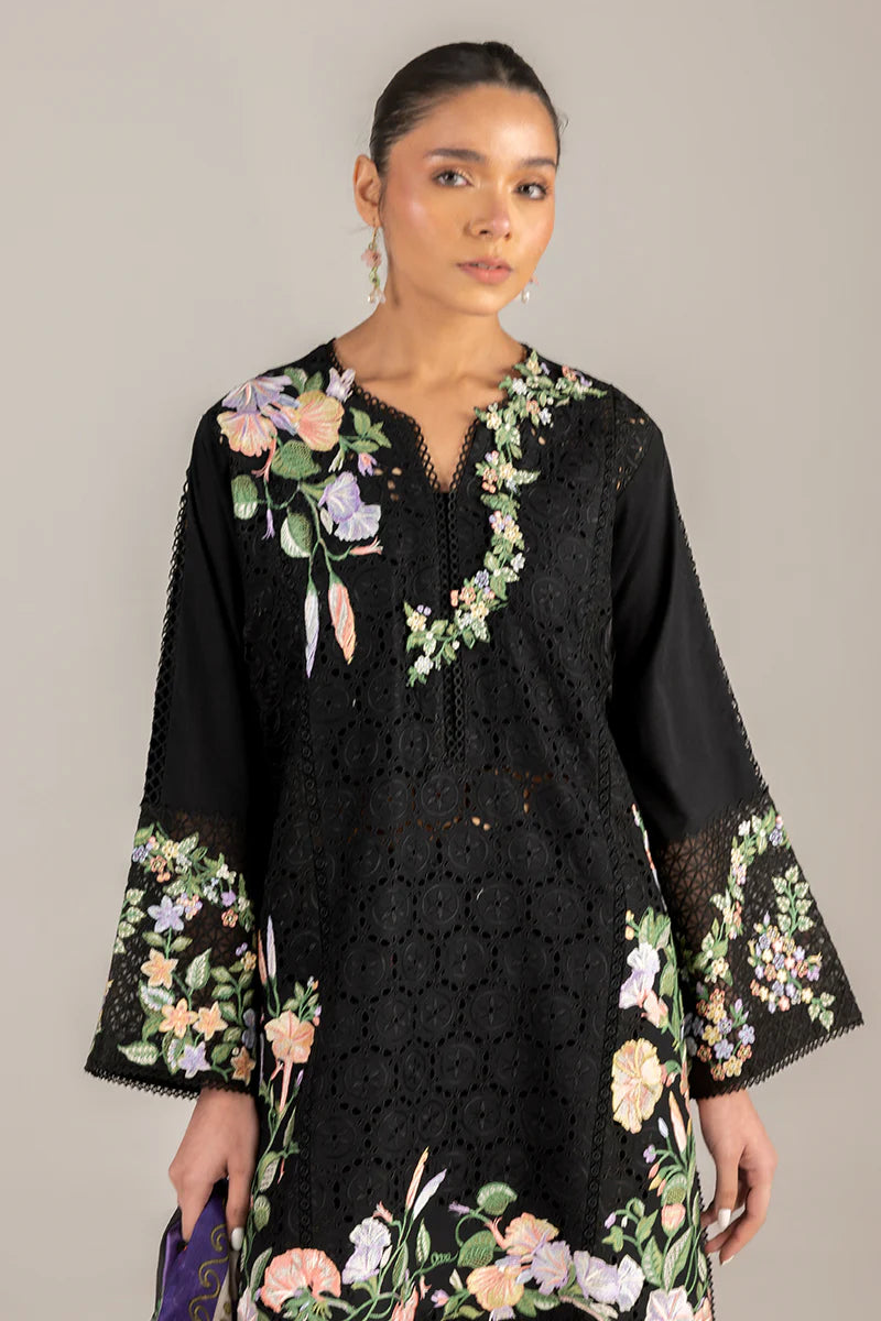 Model wearing black embroidered floral shirt with matching trousers and multicolour dupatta from Mushq Manaram Luxury Lawn 2025 Dazzling Glimmer. Pakistani clothes online UK.