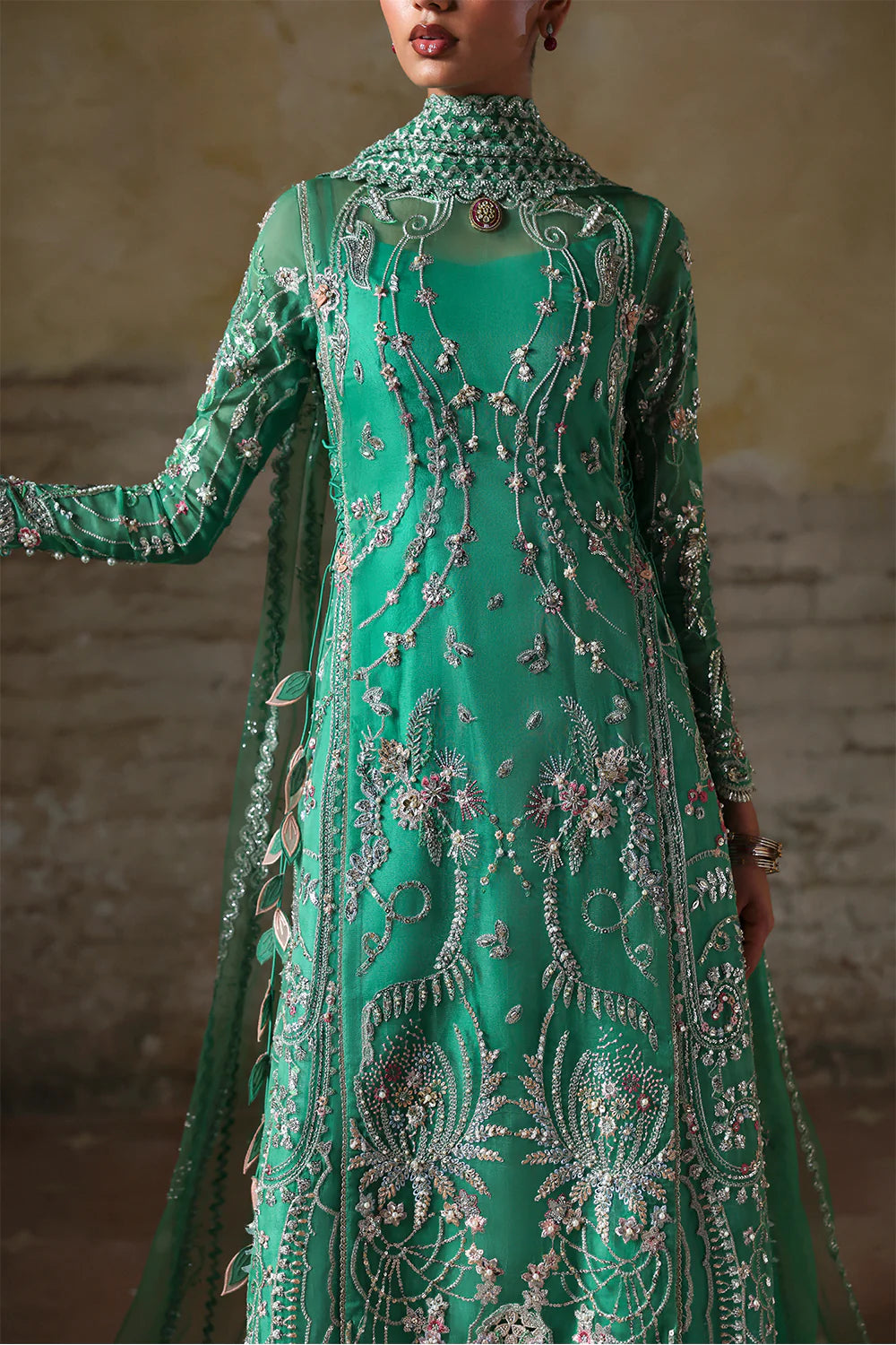Model wearing Maristella by Soraya in emerald green with silver embellishments – Pakistani luxury pret, shop Soraya clothes online in UK.
