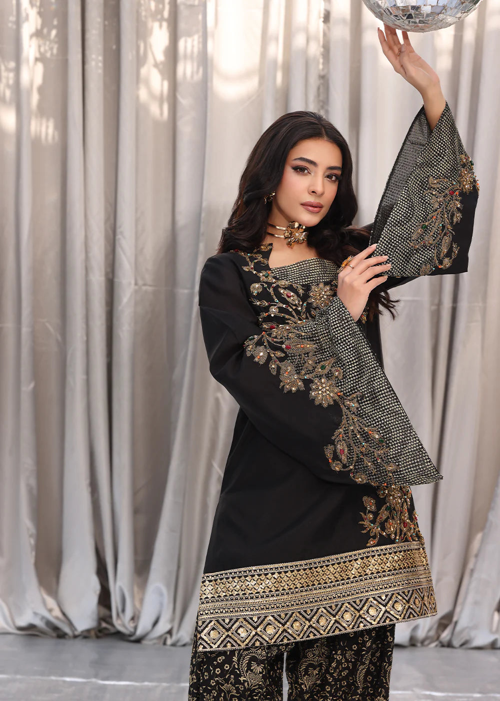 Model wearing black and gold embroidered dress with matching dupatta from Musferah Saad Midnight Bloom, Pakistani Luxury pret in UK.