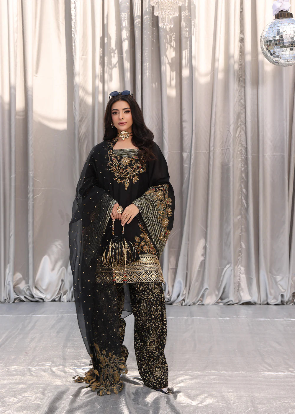 Model wearing black and gold embroidered dress with matching dupatta from Musferah Saad Midnight Bloom, Pakistani Luxury pret in UK.
