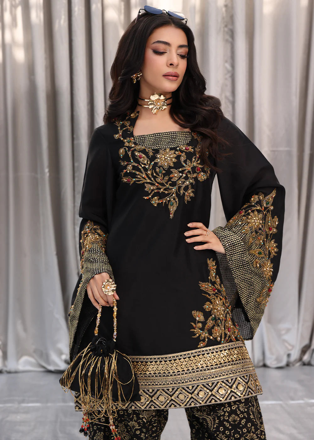 Model wearing black and gold embroidered dress with matching dupatta from Musferah Saad Midnight Bloom, Pakistani Luxury pret in UK.