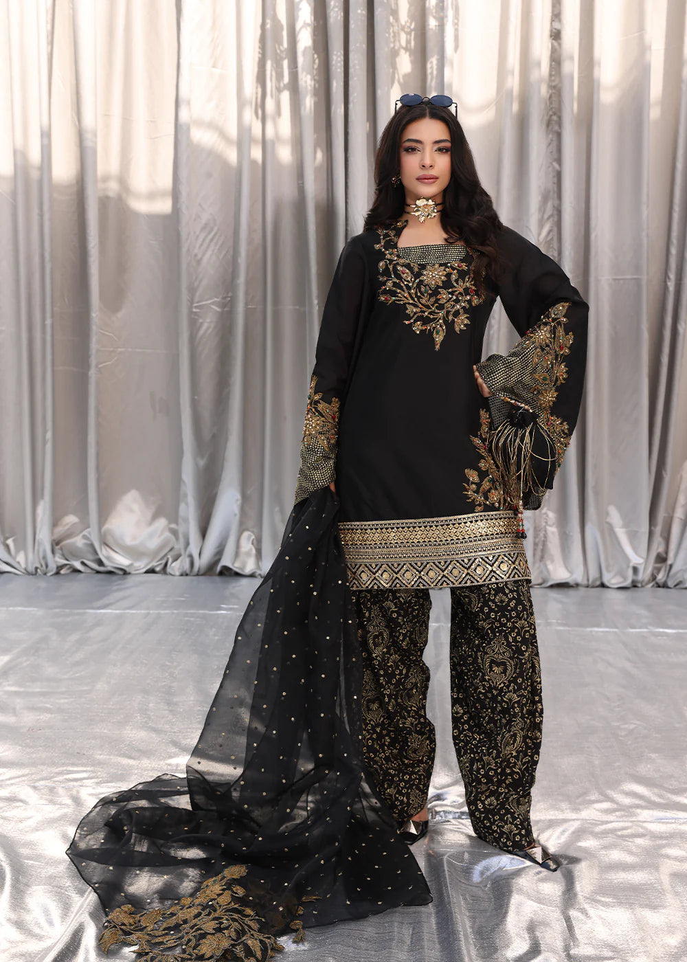 Model wearing black and gold embroidered dress with matching dupatta from Musferah Saad Midnight Bloom, Pakistani Luxury pret in UK.