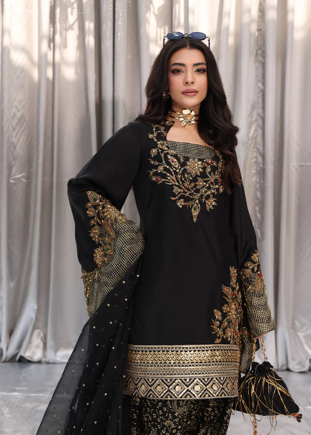Model wearing black and gold embroidered dress with matching dupatta from Musferah Saad Midnight Bloom, Pakistani Luxury pret in UK.