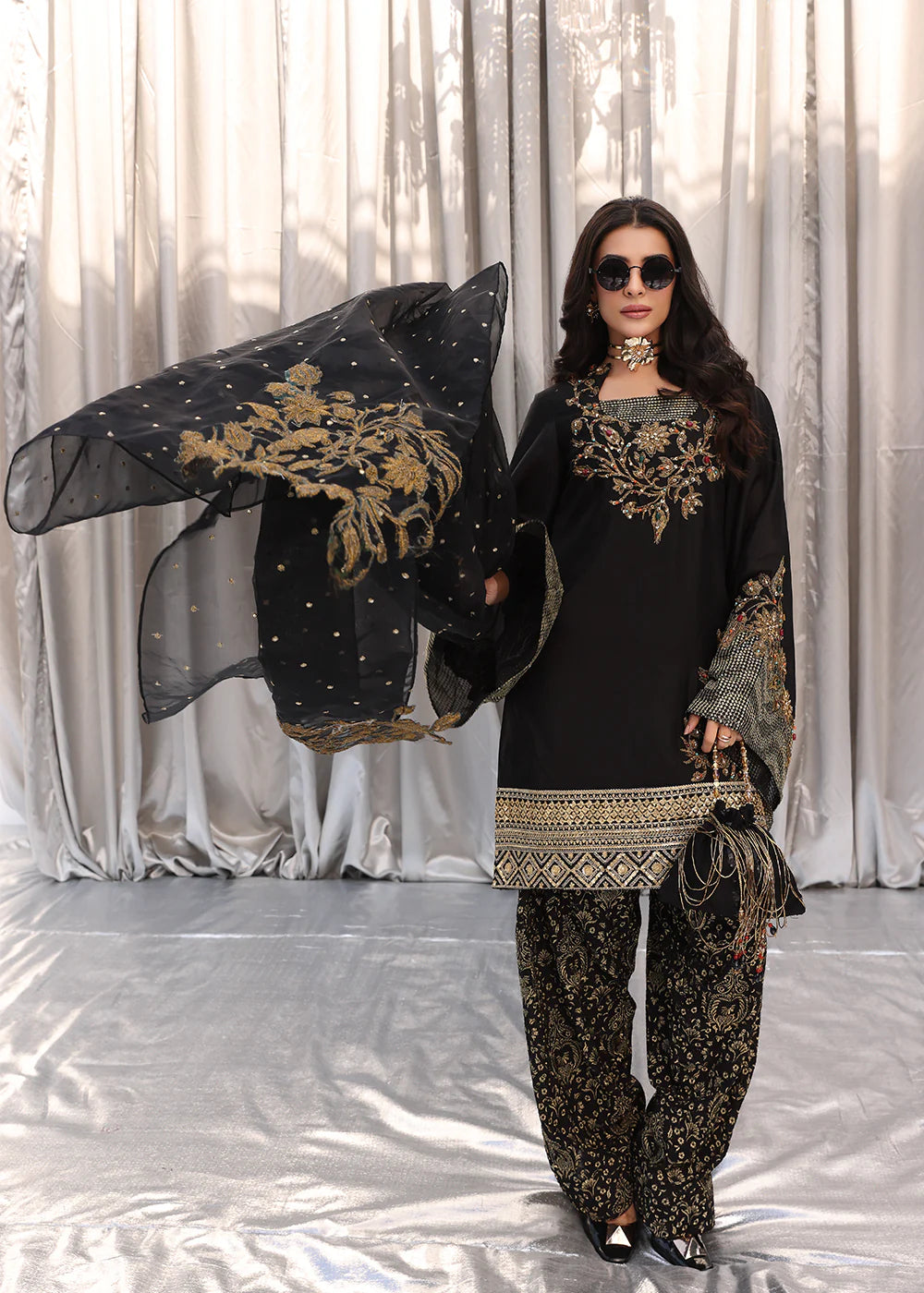 Model wearing black and gold embroidered dress with matching dupatta from Musferah Saad Midnight Bloom, Pakistani Luxury pret in UK.