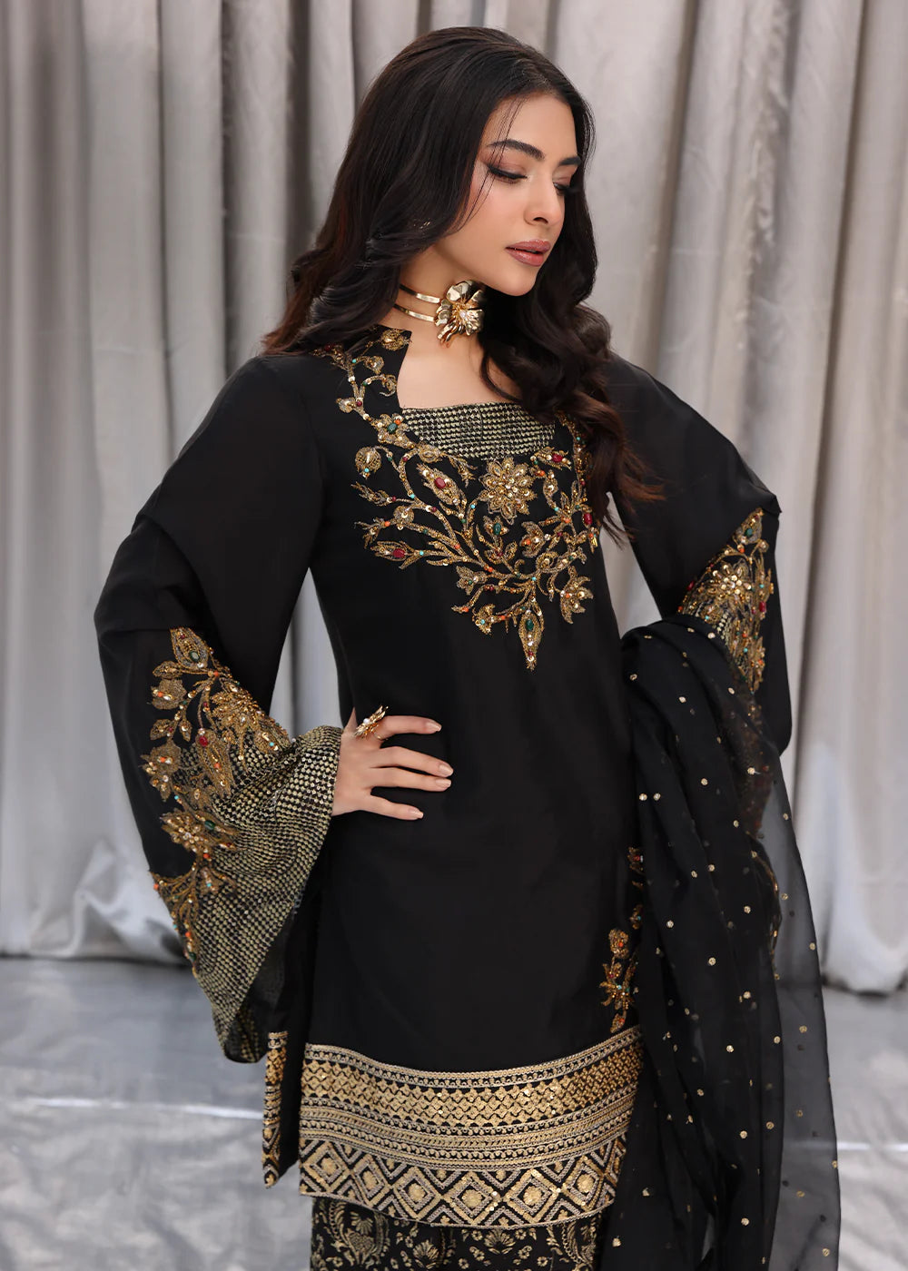 Model wearing black and gold embroidered dress with matching dupatta from Musferah Saad Midnight Bloom, Pakistani Luxury pret in UK.