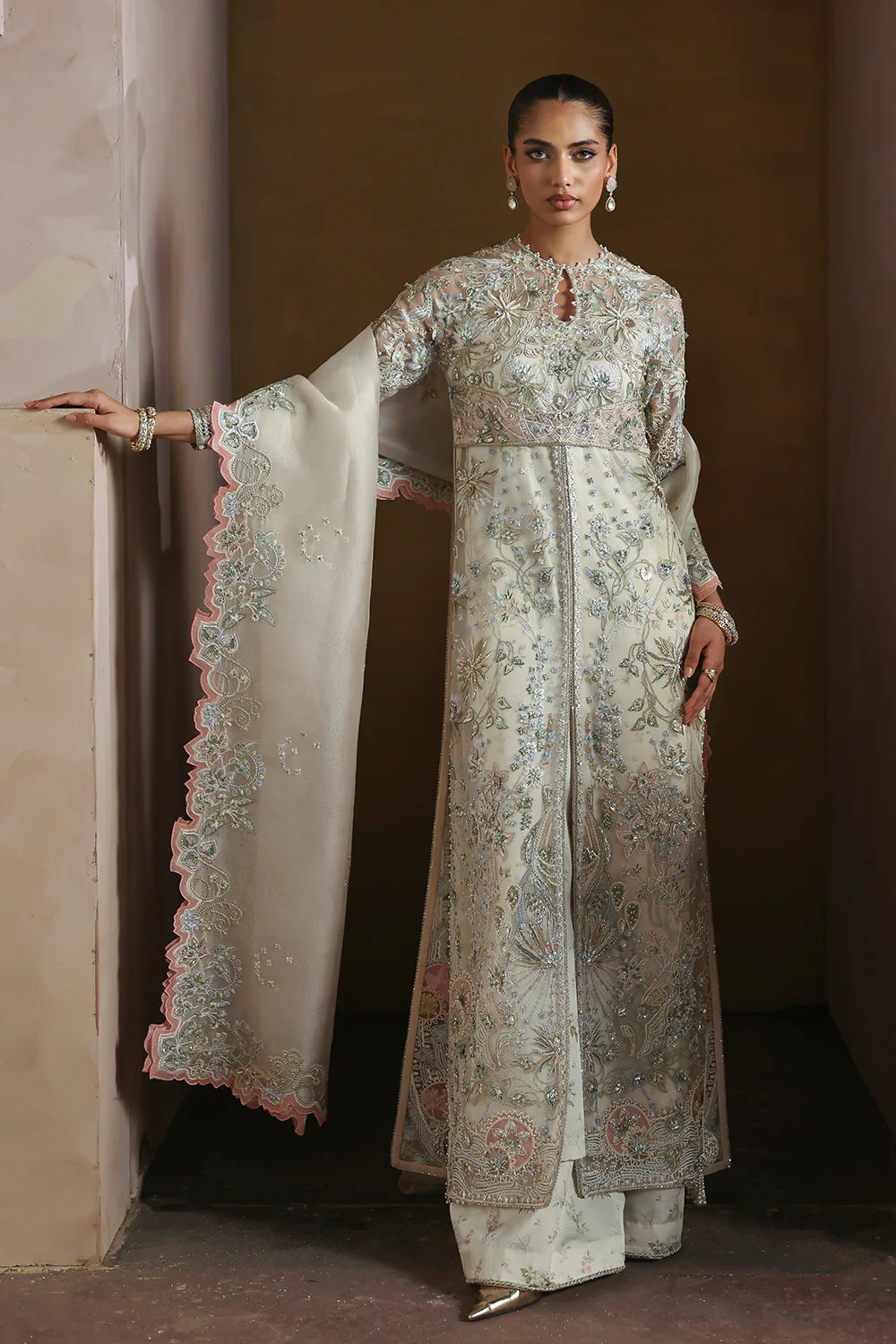 Model wearing Novara by Soraya in ivory with silver and pastel embroidery – Pakistani luxury pret, shop Soraya clothes online in UK.