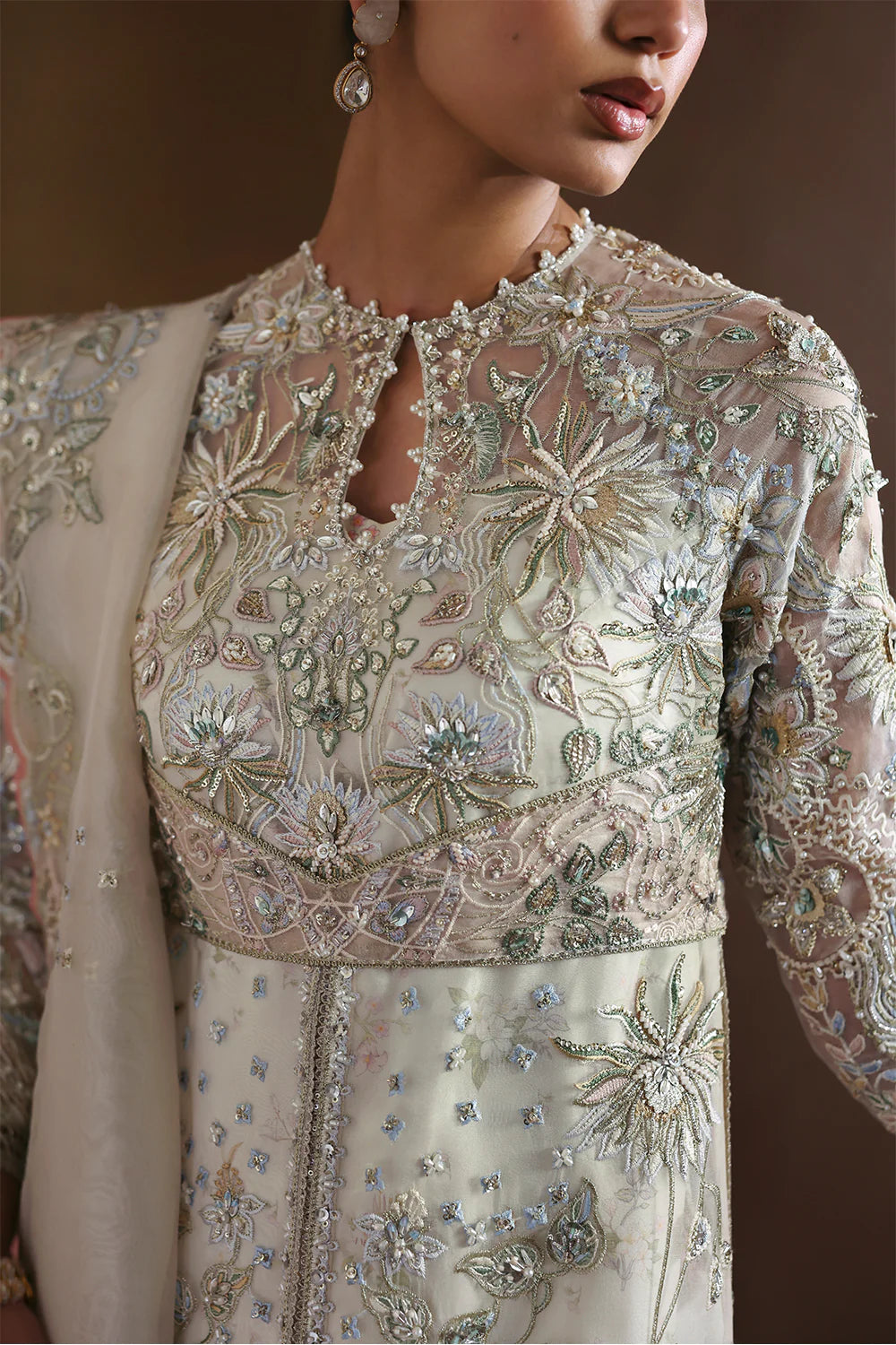 Model wearing Novara by Soraya in ivory with silver and pastel embroidery – Pakistani luxury pret, shop Soraya clothes online in UK.