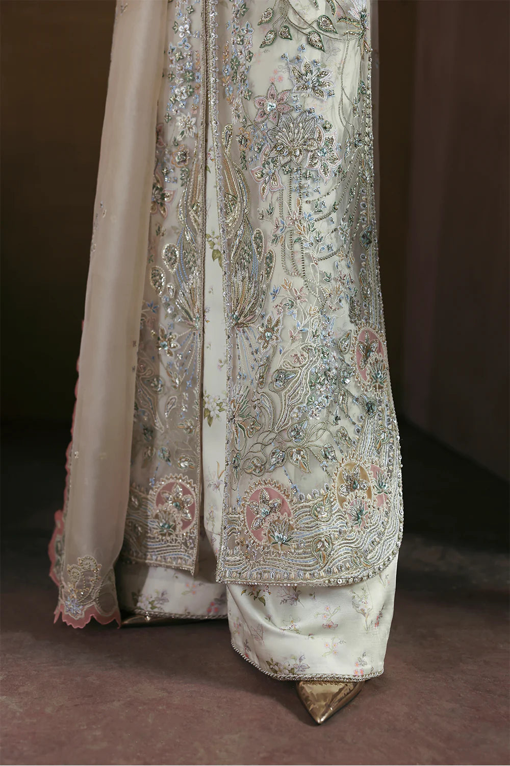 Model wearing Novara by Soraya in ivory with silver and pastel embroidery – Pakistani luxury pret, shop Soraya clothes online in UK.