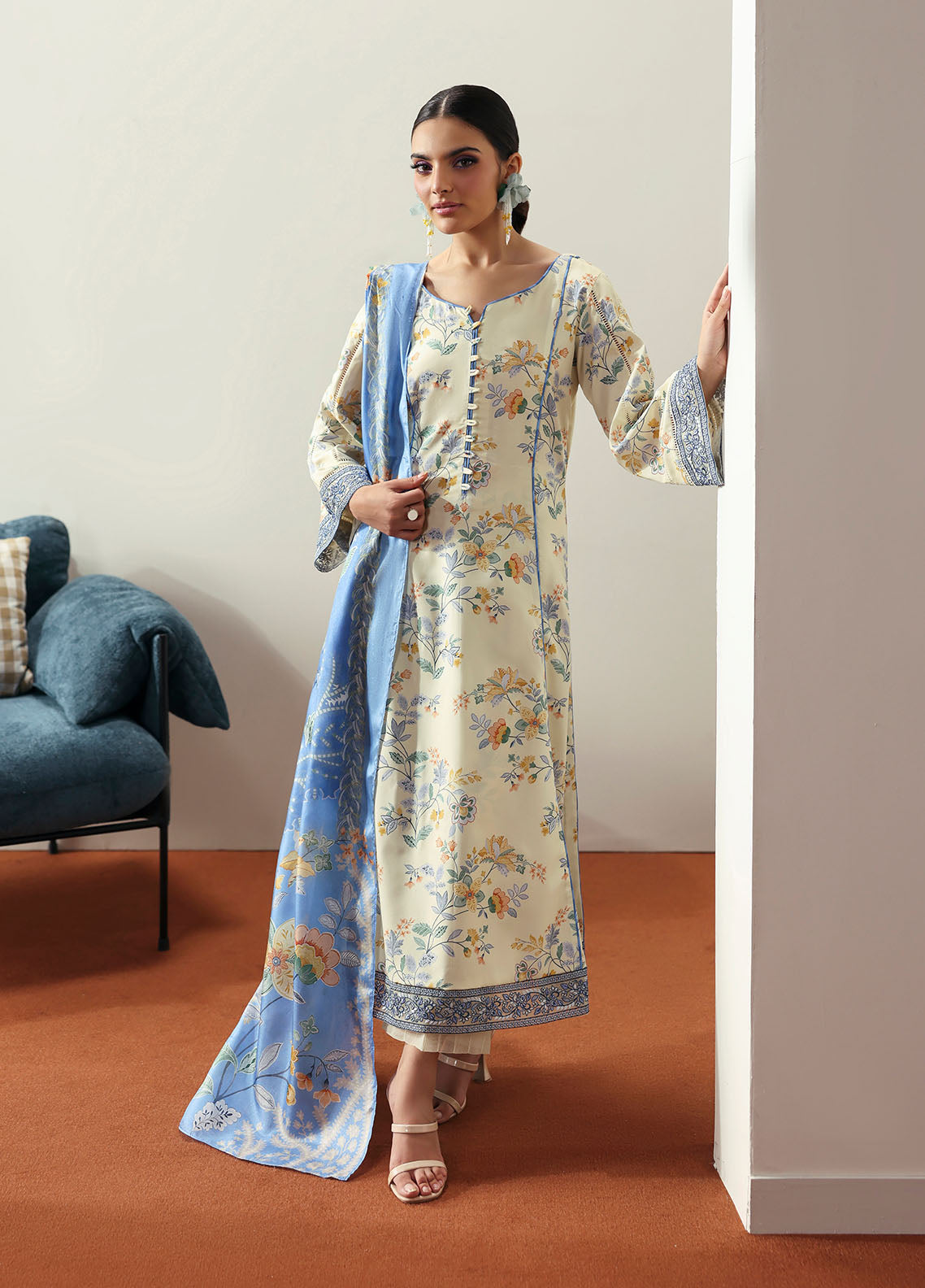 Model wearing cream and blue floral outfit from Gulaal Basics | Elaris, elegant Pakistani luxury pret available online in UK.