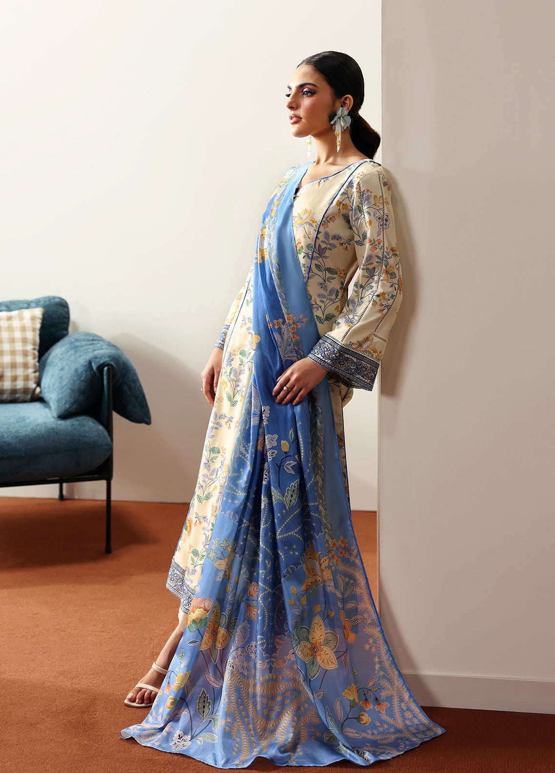 Model wearing cream and blue floral outfit from Gulaal Basics | Elaris, elegant Pakistani luxury pret available online in UK.