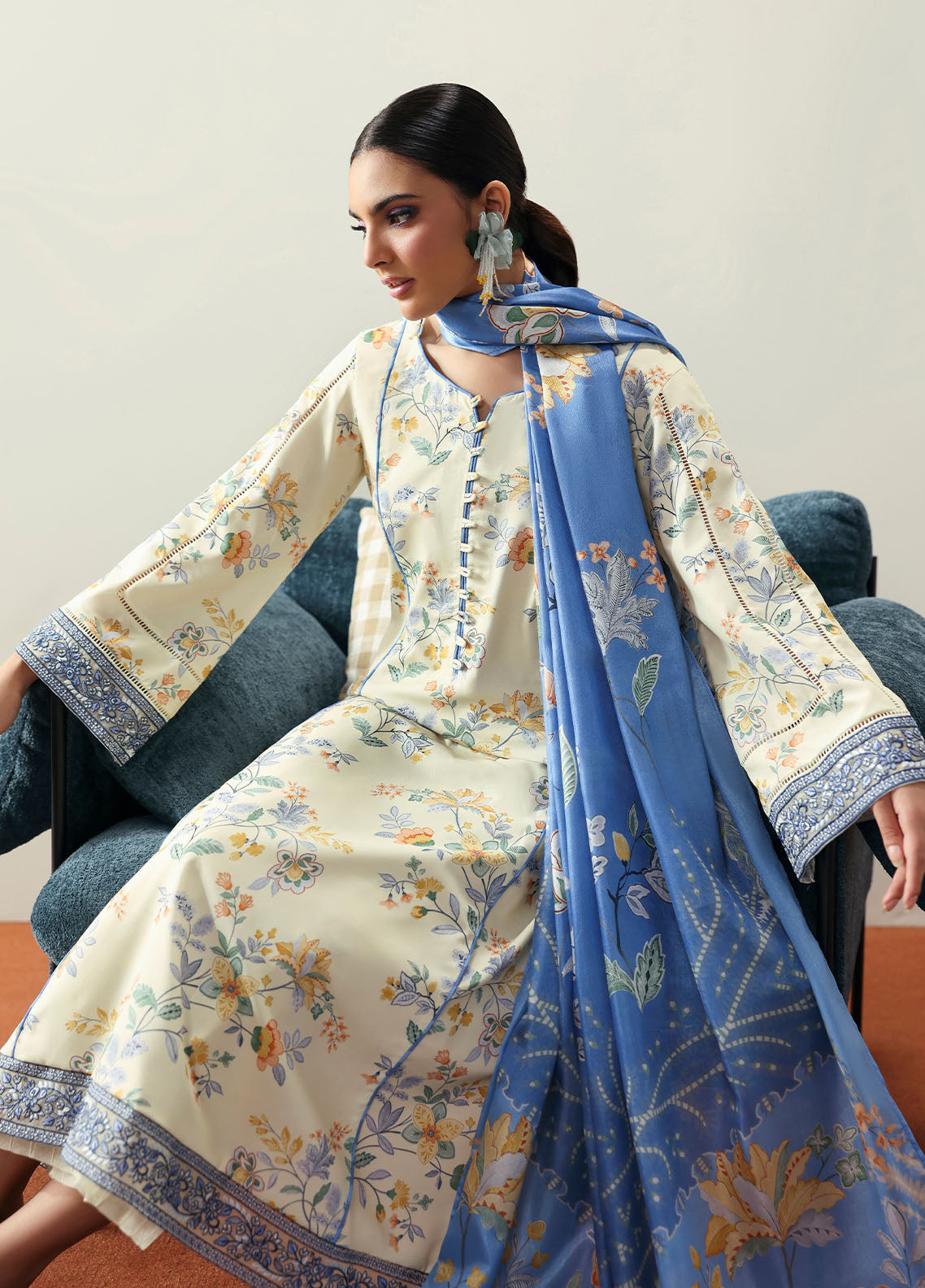 Model wearing cream and blue floral outfit from Gulaal Basics | Elaris, elegant Pakistani luxury pret available online in UK.