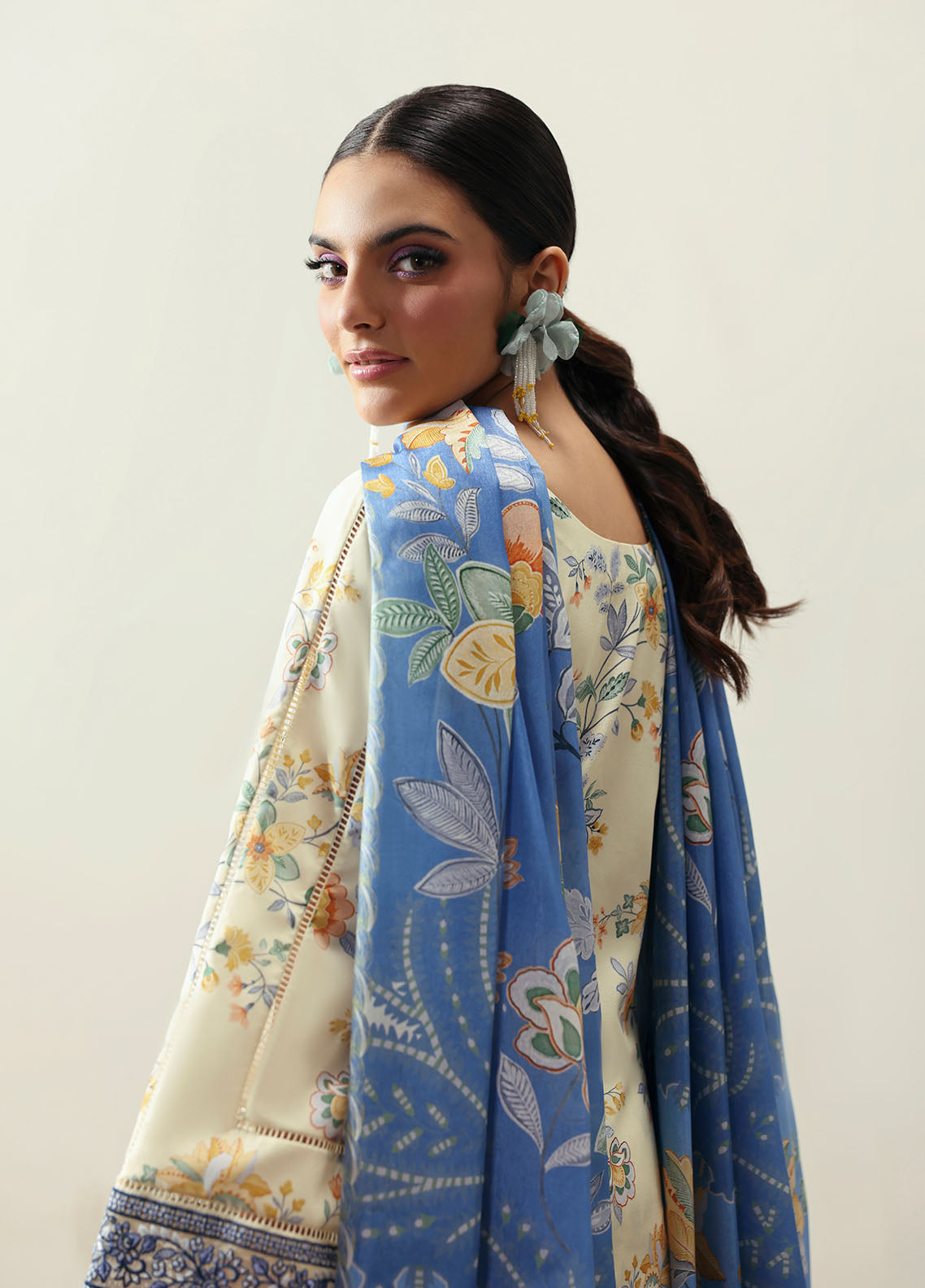 Model wearing cream and blue floral outfit from Gulaal Basics | Elaris, elegant Pakistani luxury pret available online in UK.