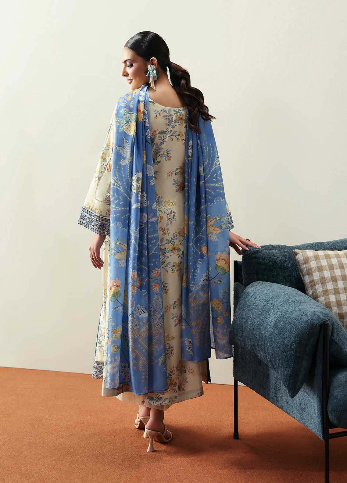 Model wearing cream and blue floral outfit from Gulaal Basics | Elaris, elegant Pakistani luxury pret available online in UK.