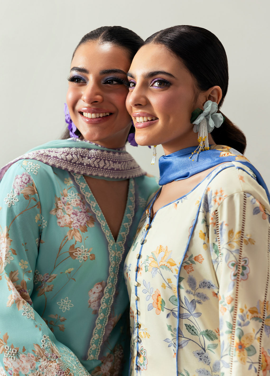 Model wearing cream and blue floral outfit from Gulaal Basics | Elaris, elegant Pakistani luxury pret available online in UK.