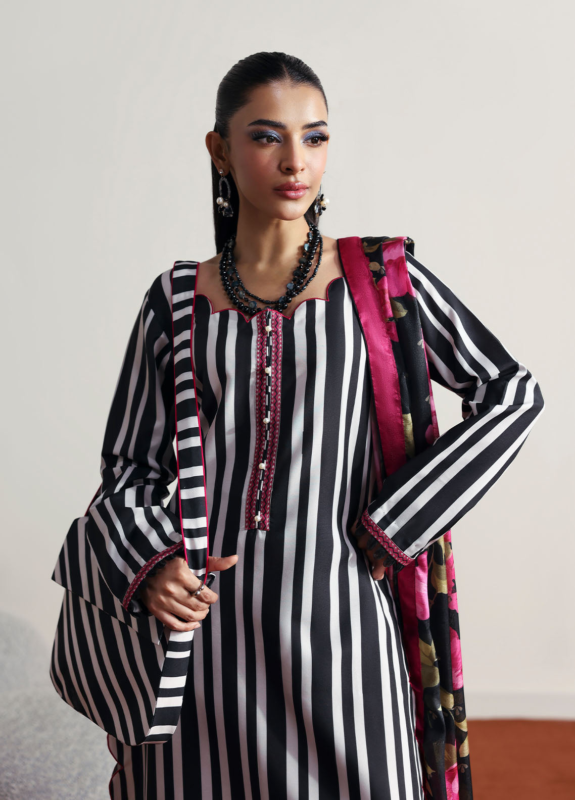 Model wearing black and white striped outfit with floral dupatta from Gulaal Basics | Fleuron, ideal Pakistani luxury pret in UK.