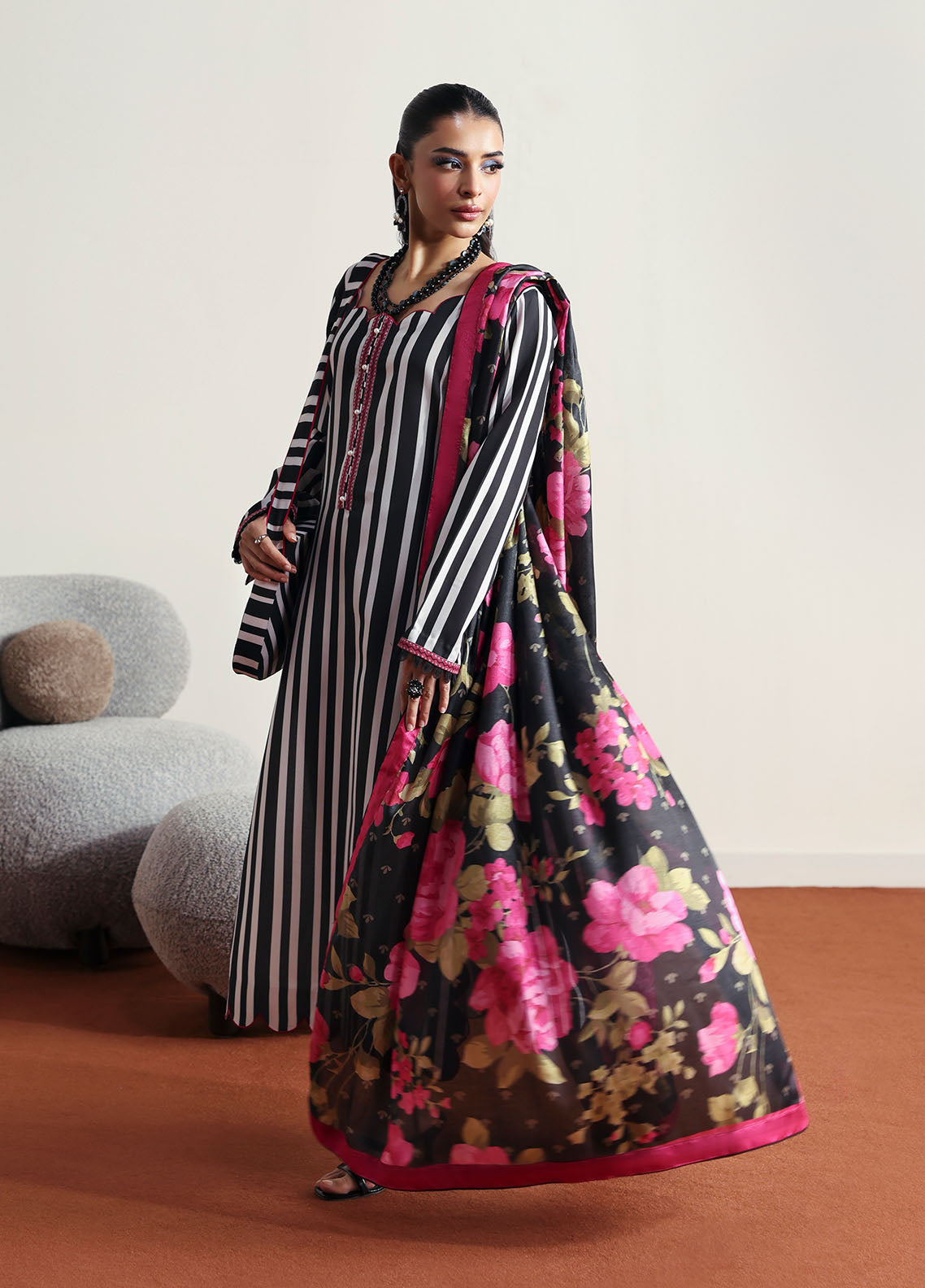 Model wearing black and white striped outfit with floral dupatta from Gulaal Basics | Fleuron, ideal Pakistani luxury pret in UK.